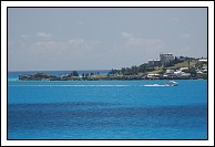 Ferry from St. George's to Dockyard rounds the corner of the island in front of Fort St. Catherine.