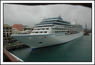 Azamara Journey, in the rain, as we move to the Customs pier.  Yep, that's my hand over the lens... oops.